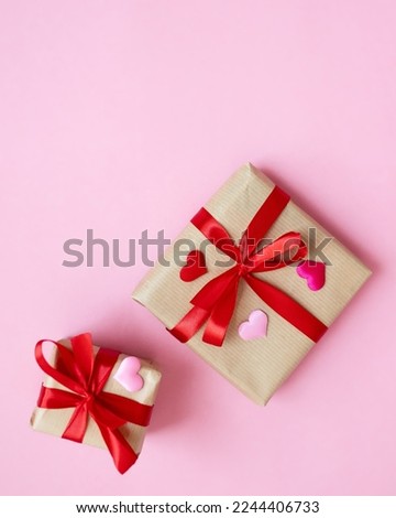 holiday background valentine's day. composition with gift, ribbons, confetti hearts on a pink background. copy space top view. flat lay. concept for February 14