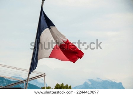 French flag flying during the day.