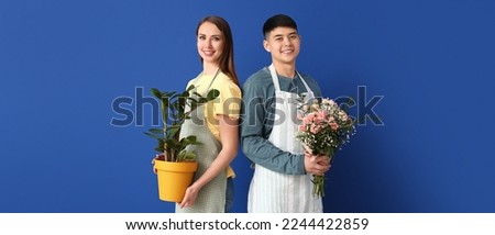 Portrait of florists with plant and bouquet on blue background