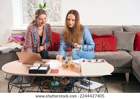 Women sit on a cozy sofa and communicate