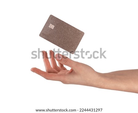 Hand and flying gold credit debit card, blank template, mockup for bank cashback advertisement isolated on white. High quality photo Royalty-Free Stock Photo #2244431297
