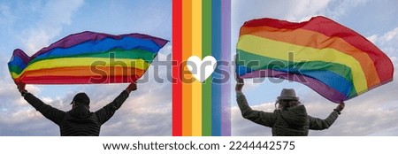 Man and woman holding a Gay Rainbow Flag  over blue summer sky. Bisexual, gay, lesbian	