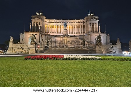 View on the Altare della Patria from Piazza Venezia at night time and cars crossing Royalty-Free Stock Photo #2244447217