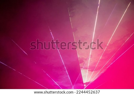 Light show. Laser show. Night club, lights, smoke machine. Pink background