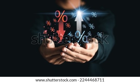 Businessman showing percentage icons and up and down arrow icons with graph indicators. Concept of financial interest rates and mortgage rates. Interest Rates Stocks Finance Ratings Mortgage Rates.