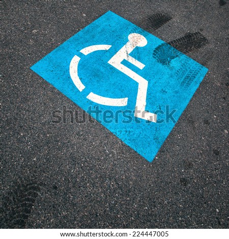 Invalid blue color street sign on a dark asphalt. 