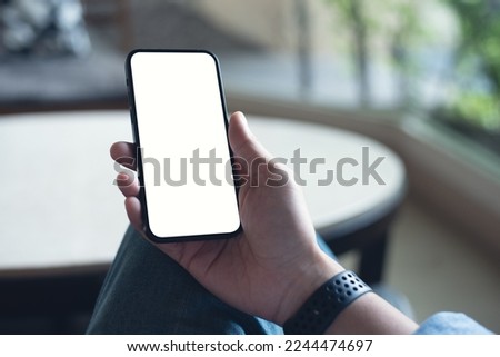 Mobile phone mockup for advetising. Mock up image of man hand holding and using smartphone with blank screen for mobile app design or text advertisement, people lifestyle