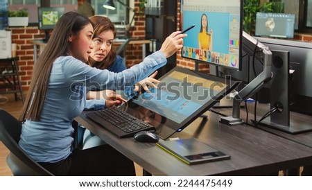 Color grading editors retouching professional photos with editing software and stylus, working on multimedia content. Diverse graphic designers processing pictures using tablet and touchscreen.