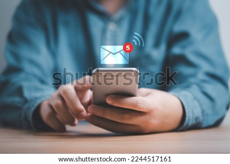 Businessman using smartphone and touching with virtual white newsletter for electronic mail or E-mail with notification alert concept.