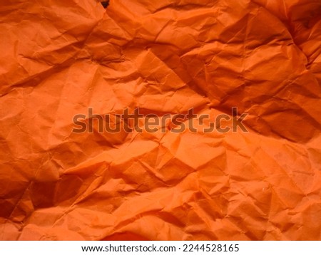 Paper texture. Textured crumpled orange paper background. Wrinkled texture. Horizontal