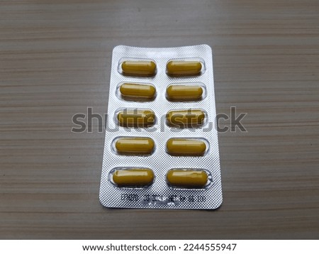 Pill medicine on a wooden table background.