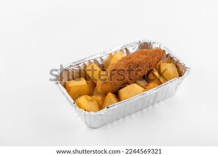 close-up of homemade lunch of potatoes and chicken cutlet in a lunch box