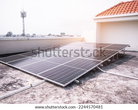 Solar Panels Solar Cells on Rooftop House Technology Home Building with Sun Overlight Day,Plant Smart Solar System Micro Inverter Solar Panels Energy on Roof House,Electric Eco Environment ecology. Royalty-Free Stock Photo #2244570481