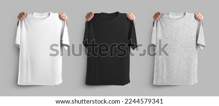 Mockup of white, black, heather t-shirts, holding hands on the shoulders of oversized clothes, place for design, pattern, branding. Set of fashion modern unisex apparel, isolated on background, front Royalty-Free Stock Photo #2244579341