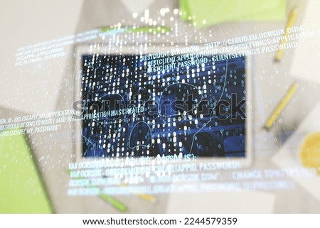 Creative code skull hologram and modern digital tablet on desktop on background, top view, cybercrime and hacking concept. Multiexposure