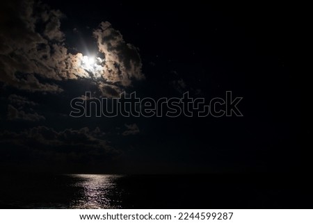 Night beach, sea and moonlight with clouds