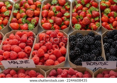 Blackberries, raspberries and strawberries boxes at Ljubljana Central Market in Slovenia.
Translated text at the picture:
- Maline: raspberries
- Robide: blackberries