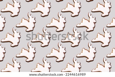 Seamless pattern of cookies in the shape of White deer, on a gray background, minimal print for new year card or wrapping paper. Happy new year and merry christmas concept