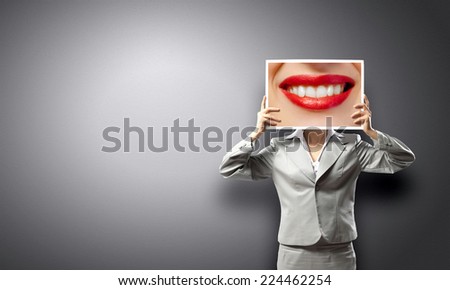 Unrecognizable businesswoman holding big photo with lips