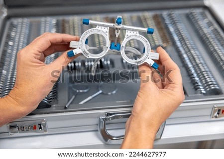 Doctor working with optometric equipment in clinic Royalty-Free Stock Photo #2244627977