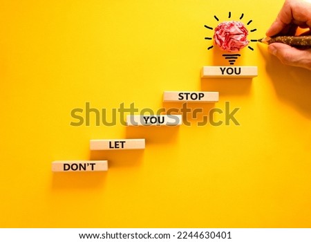 Do not let stop you symbol. Wooden blocks with words Do not let you stop you on beautiful yellow background, copy space. Businessman hand, light bulb icon. Business, do not let stop you concept. Royalty-Free Stock Photo #2244630401