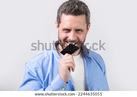 guy biting business card. photo of guy hold business card. guy show business card