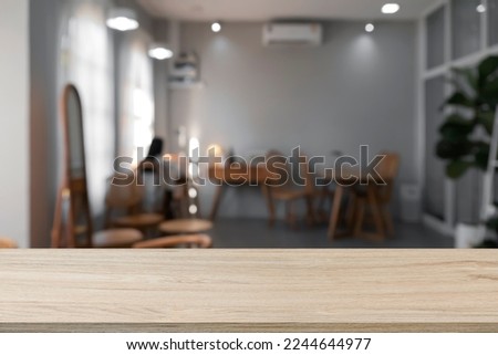 Empty wooden table with blurry background of cafe and restaurant.