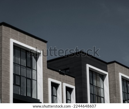  new apartment building over sky. Modern multistoried modern, new and stylish living block of flats.