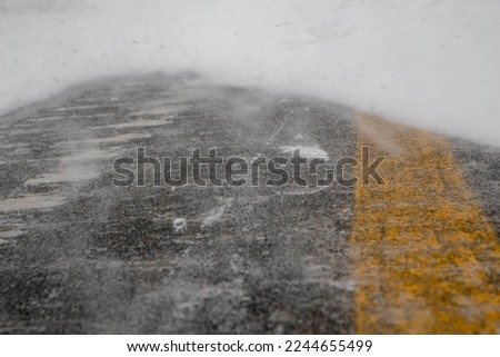 road in winter. Close-up of snow on the road. Impossibility of taking a vehicle. Snow storm. Transport impossible with snow. Road covered with snow in the middle of a storm, blizzard,winter