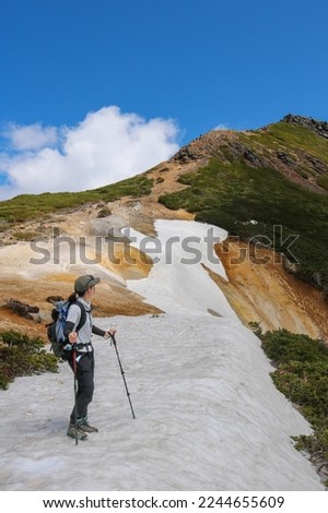 A picture of a woman climbing a mountain