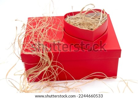 Red heart shaped gift box on white background, Valentine's Day or birthday concept, copy space area,