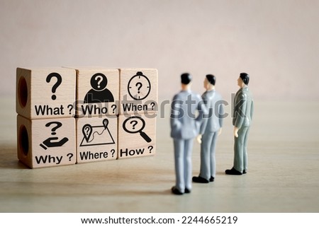5W1H,Root cause analysis, investigation, inquiry, analysis, problem solving,critical thinking,brainstorming, creativity,and innovation concept.,Business person looking wooden cubes with 5w1h icon. Royalty-Free Stock Photo #2244665219