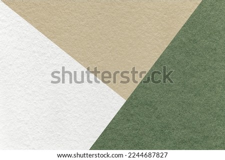 Texture of craft white, green and beige shade color paper background, macro. Structure of vintage abstract olive cardboard with geometric shape and gradient. Felt backdrop closeup.