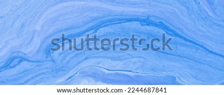 Abstract fluid art background light blue colors. Liquid marble. Acrylic painting on canvas with denim gradient. Watercolor backdrop with wavy pattern. Stone section.