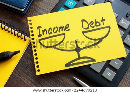 Debt to income ratio DTI concept. Page from a notebook with drawn weights lies on a calculator. Royalty-Free Stock Photo #2244690213