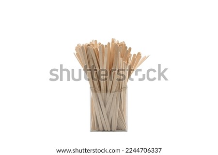 Organizer with coffee stirrers on isolated background Royalty-Free Stock Photo #2244706337