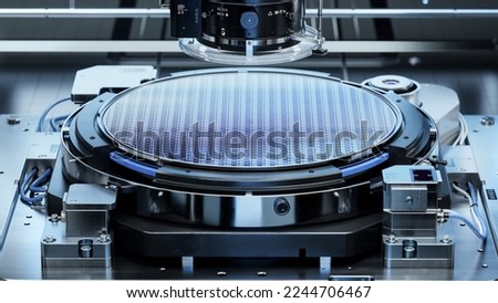 Silicon Wafer during Photolithography Process. Shot of Lithography Process that allows to Create Complex Patterns on a Wafer during Semiconductor and Computer Chip Manufacturing at Fab or Foundry. Royalty-Free Stock Photo #2244706467