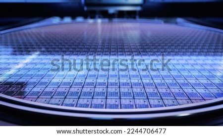 Macro Shot of a Silicon Wafer during Semiconductor and Computer Chip Manufacturing at Fab or Foundry. Semicondutor Wafer Texture. Royalty-Free Stock Photo #2244706477
