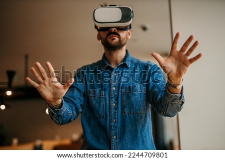 Handsome men using glasses of virtual reality at home. Future gadgets technology concept. Modern imaging