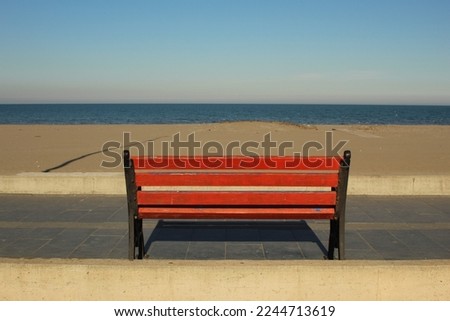 An alone bench in front of the sea view. High quality photo