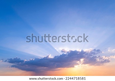 sunset or sun rise sky with rays of  light shining clouds and sky background and texture