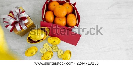Banner objects of red envelopes with money for angpao, oranges, blank sign, golds, gift for celebrating Chinese New Year to present prosperity, wealth, healthy with copy space.