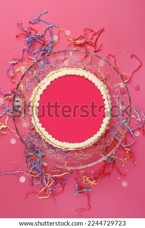 Birthday cake with empty space for text or picture. Beautiful pink cake over pink background with festive decorations. Top view, copy space, flat lay