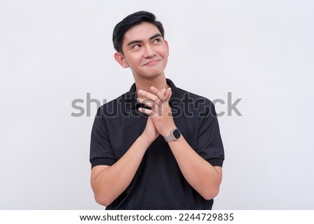A clever and devious man rubs his hands in anticipation of his plan coming into fruition. Isolated on a white background. Royalty-Free Stock Photo #2244729835