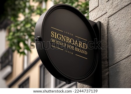 Blank round black signboard on the wall outdoor, mock up for logo design, brand presentation for companies, shops.