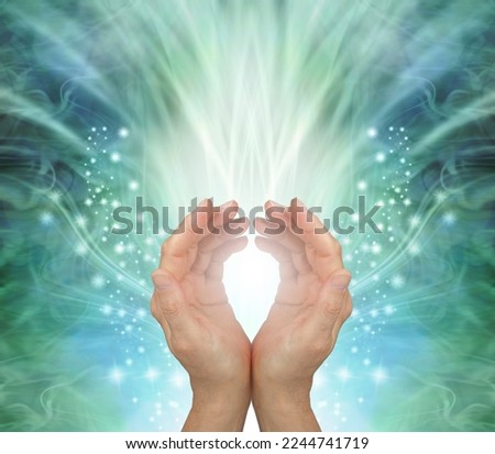 Channeling heart chakra healing energy to you - female cupped hands against a stunning radiating ethereal green energy field background with copy space for messages
 Royalty-Free Stock Photo #2244741719