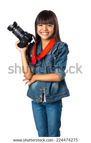 Smiling young asian girl holding photo camera, Isolated over white