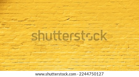 Yellow street brick wall background or texture Royalty-Free Stock Photo #2244750127