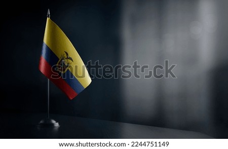 Small national flag of the Ecuador on a black background