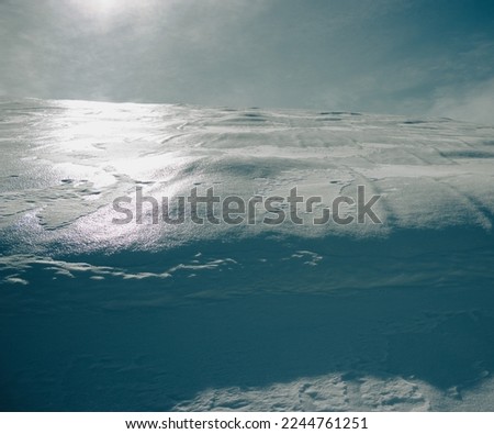 Surface of a mountain covered with snow. Sunlit snowy surface. Photographed in Combai, Treviso, Italy.